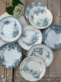 I. Set of 8 assorted dinner plates