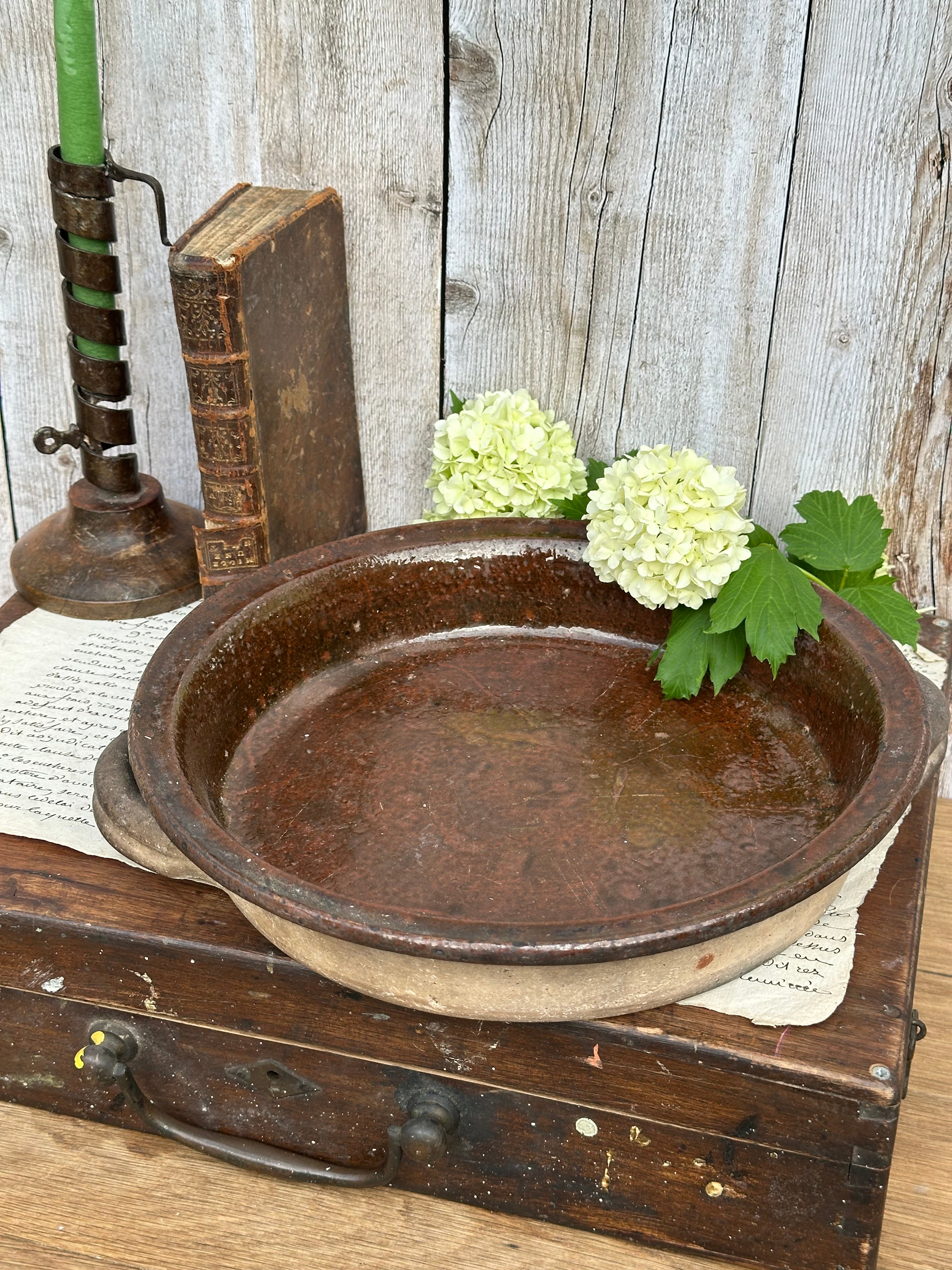 Patinated glazed dish, signed Vallauris, diameter 27.6cm