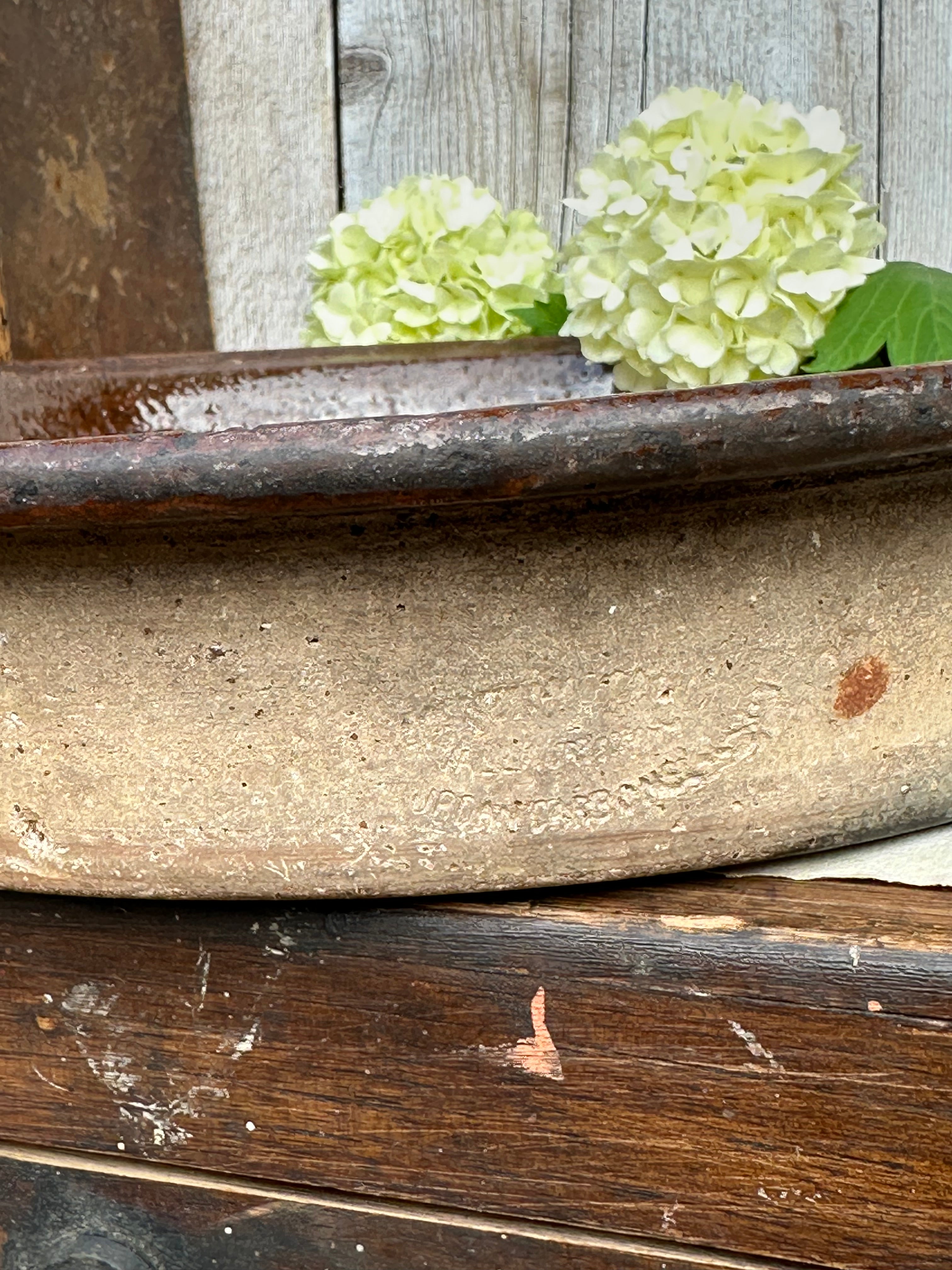 Patinated glazed dish, signed Vallauris, diameter 27.6cm
