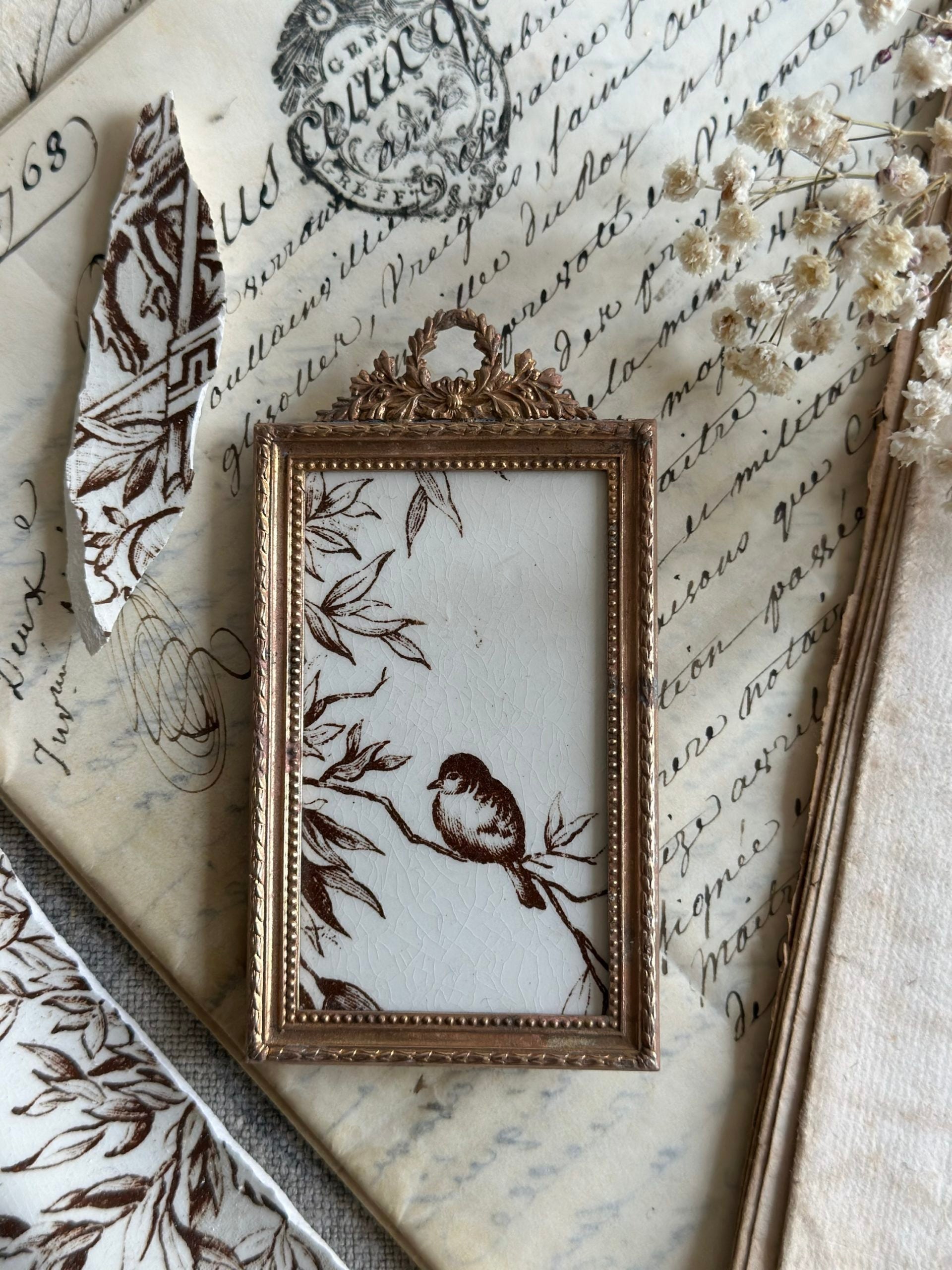 Petit cadre ancien terre de fer oiseau sur la branche