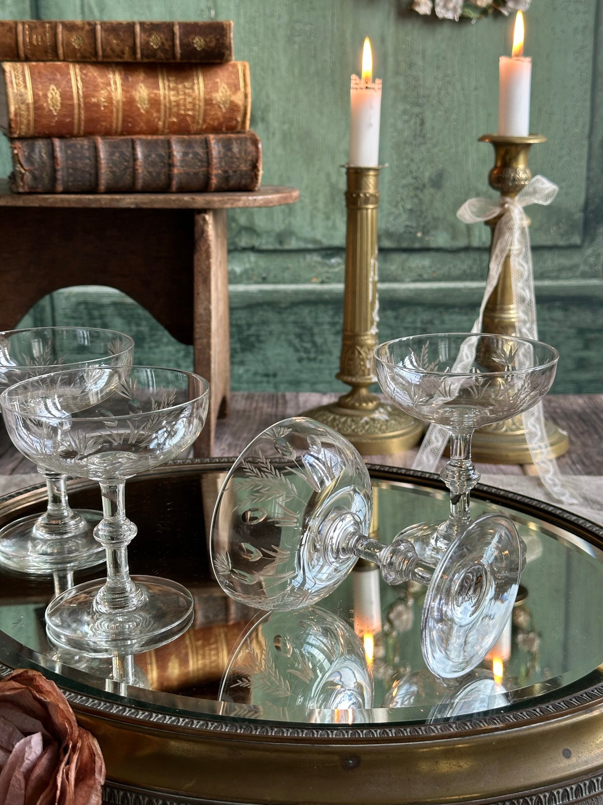 Exceptional set of four antique crystal champagne coupes with discreetly gilded motifs.