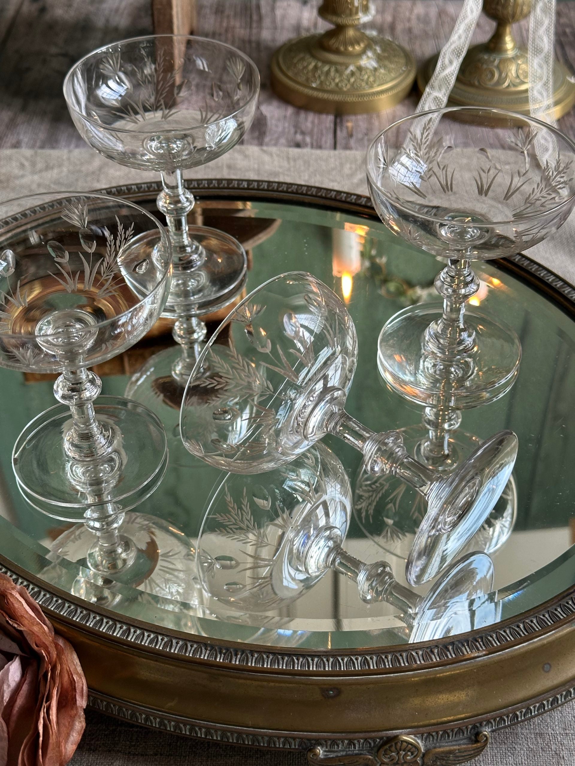 Exceptional set of four antique crystal champagne coupes with discreetly gilded motifs.