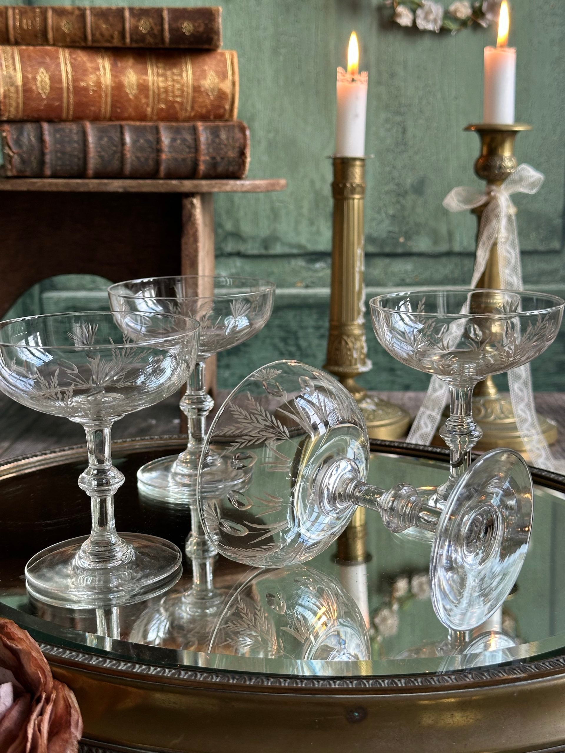 Exceptional set of four antique crystal champagne coupes with discreetly gilded motifs.