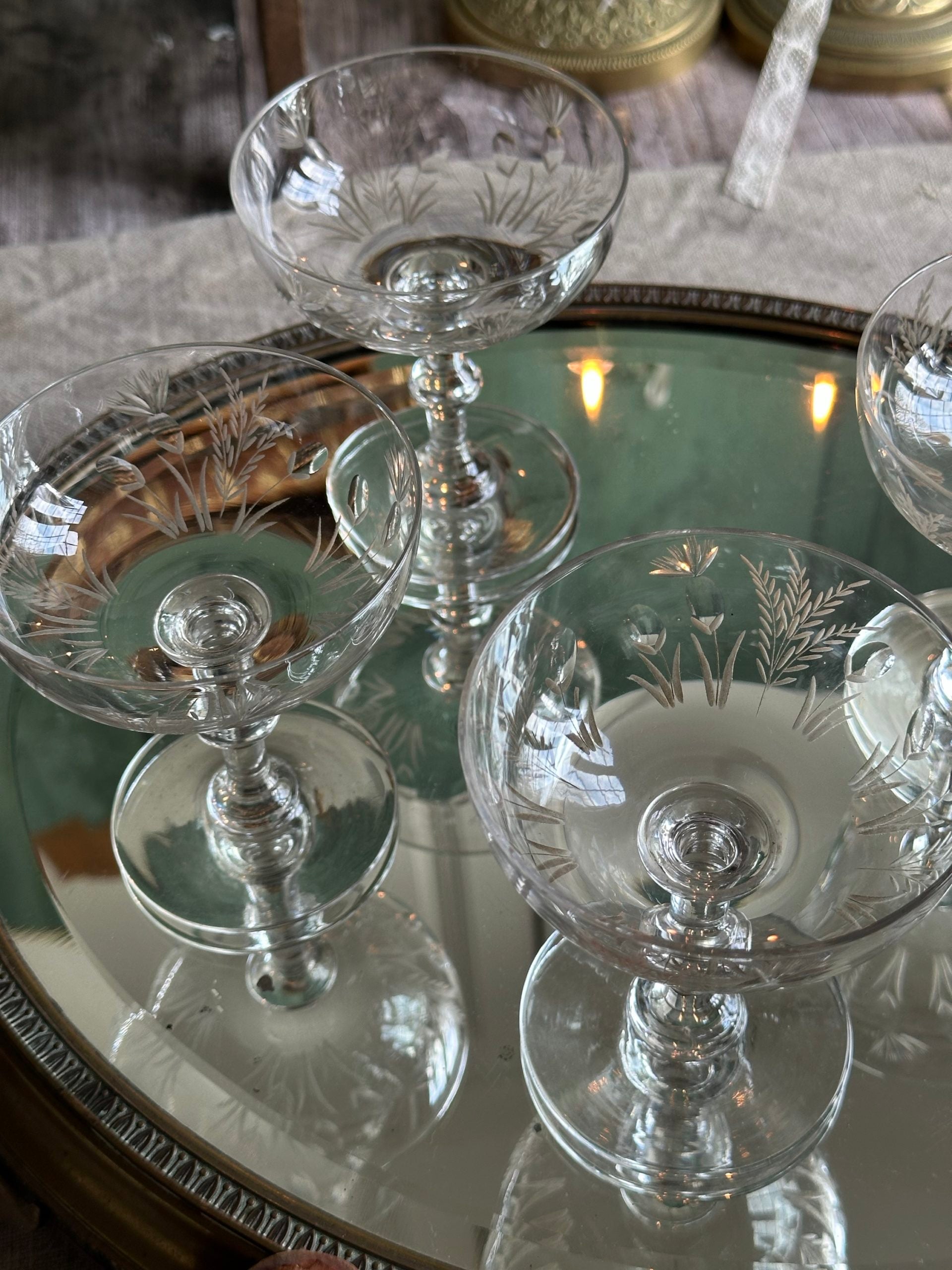 Exceptional set of four antique crystal champagne coupes with discreetly gilded motifs.