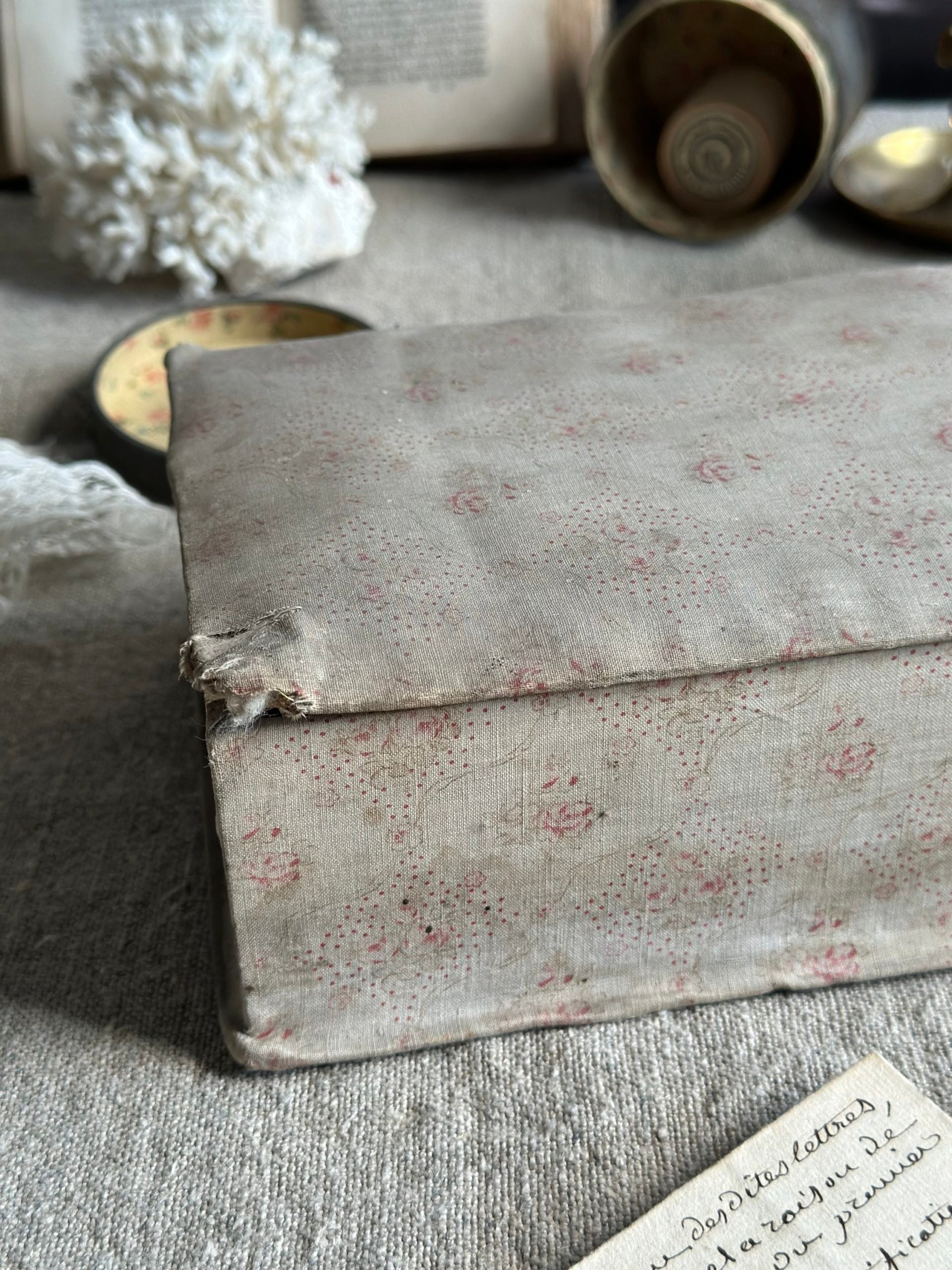 V. Antique sewing box covered in fabric