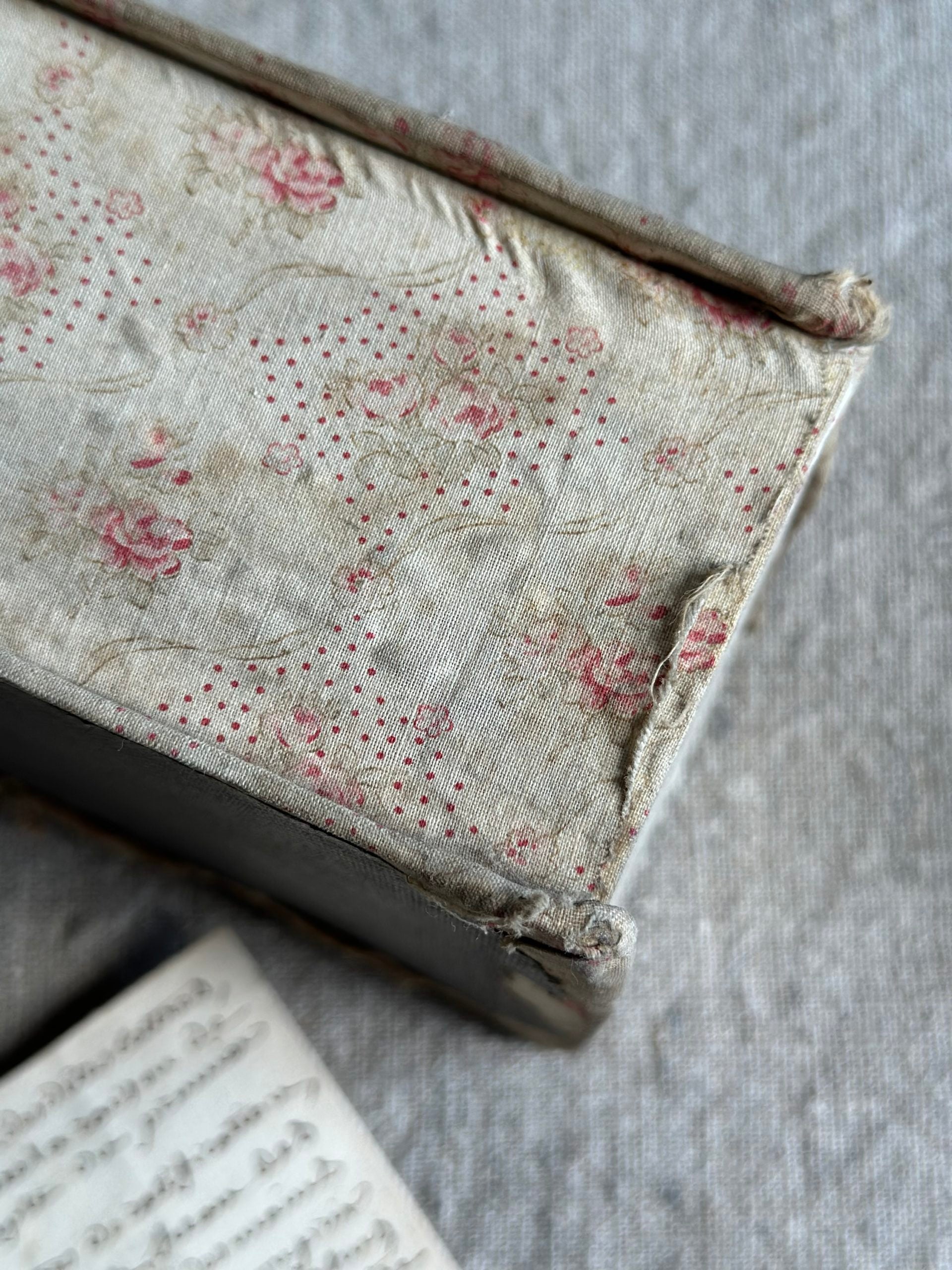 V. Antique sewing box covered in fabric