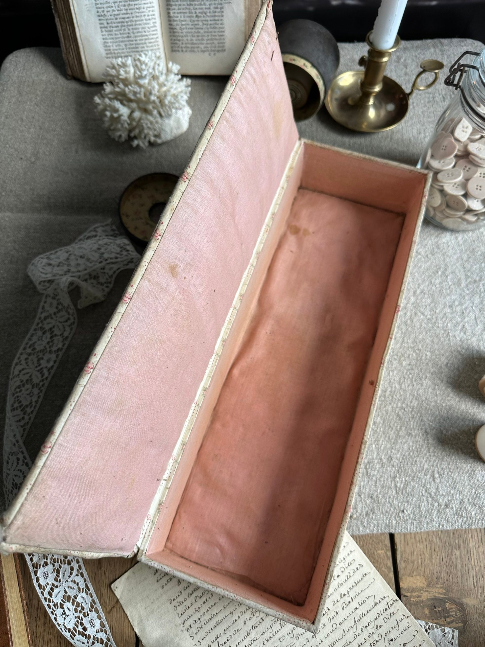 V. Antique sewing box covered in fabric